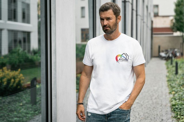 Man wearing white t-shirt with logo.